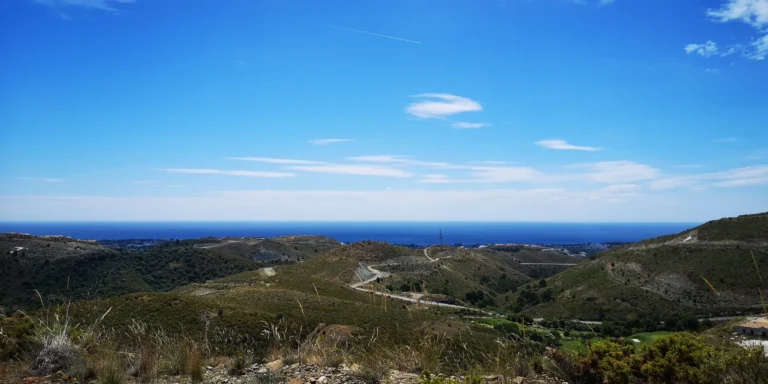 Green hills and a winding road running down towards the Mediterranean coast